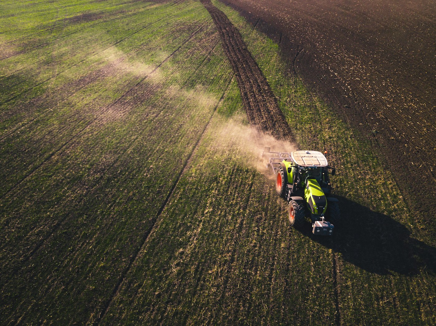 Aerial view of a tractor applying treatment to a field
